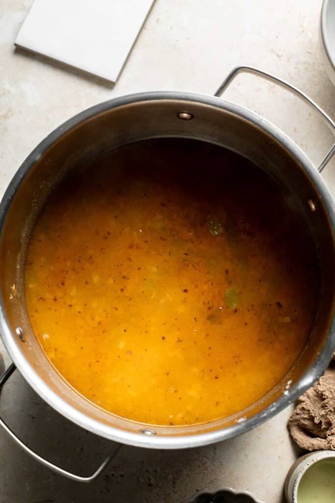 Golden chili base in the pot after simmering.