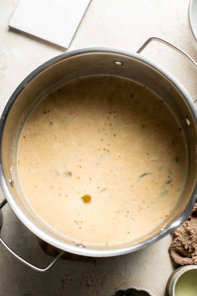 Creamy white bean chili in the pot after the cream is stirred in.