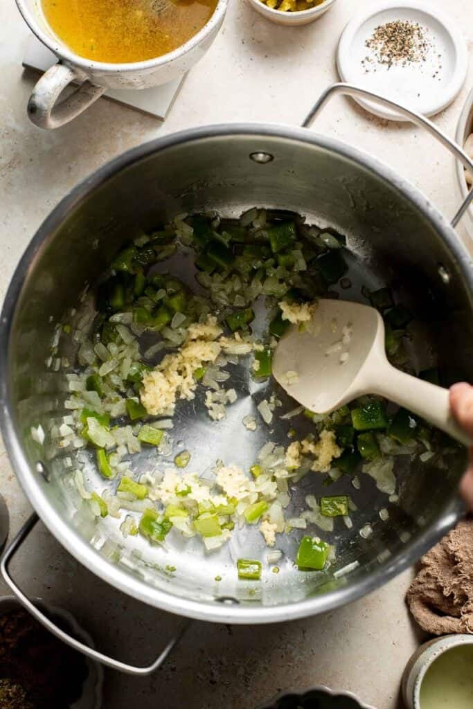 Garlic cooking with the onion and peppers in the pot.