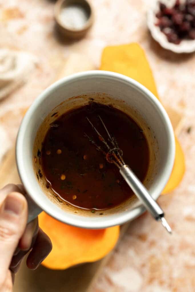 Whisking the maple butter mixture for hasselback butternut squash.