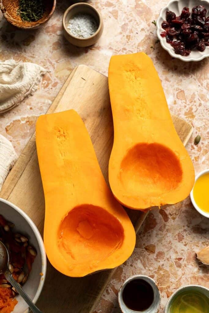 Butternut squash halves with the seeds scooped out.