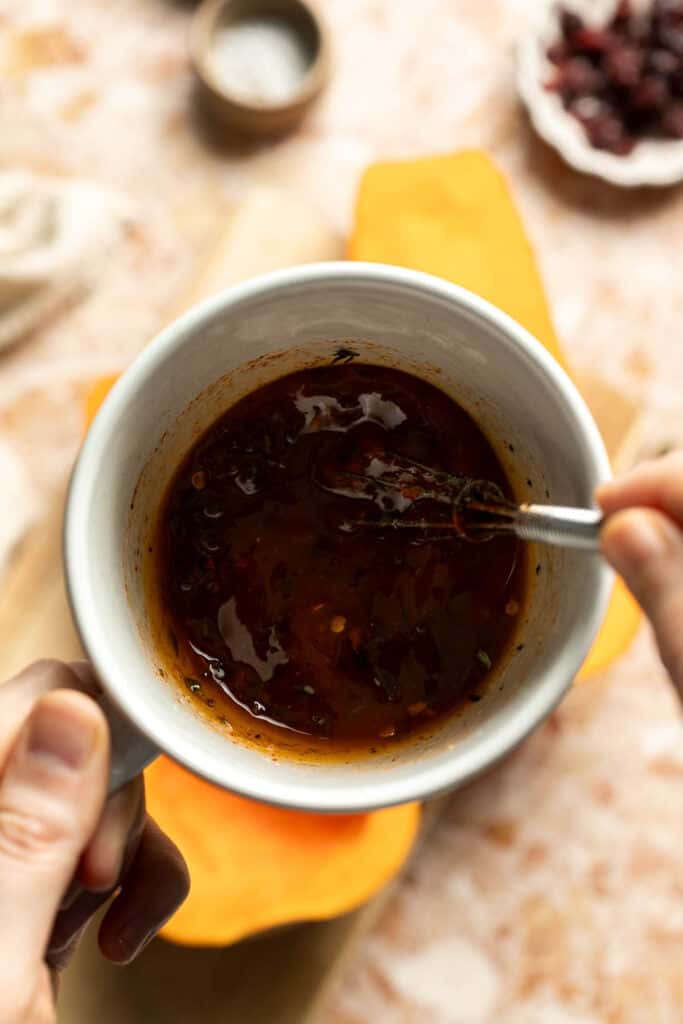 Maple butter mixture with garlic and thyme in a bowl.