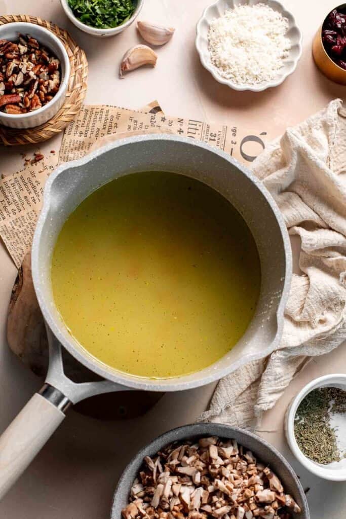 Saucepan of vegetable broth on the stove.