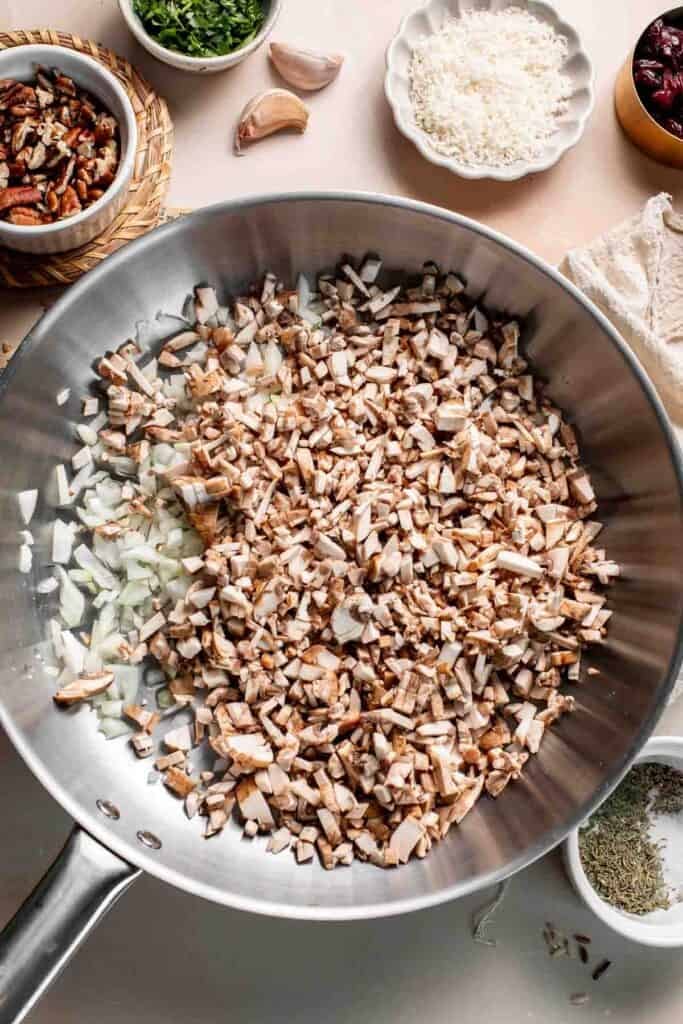 Chopped mushrooms and onion in the skillet before cooking.
