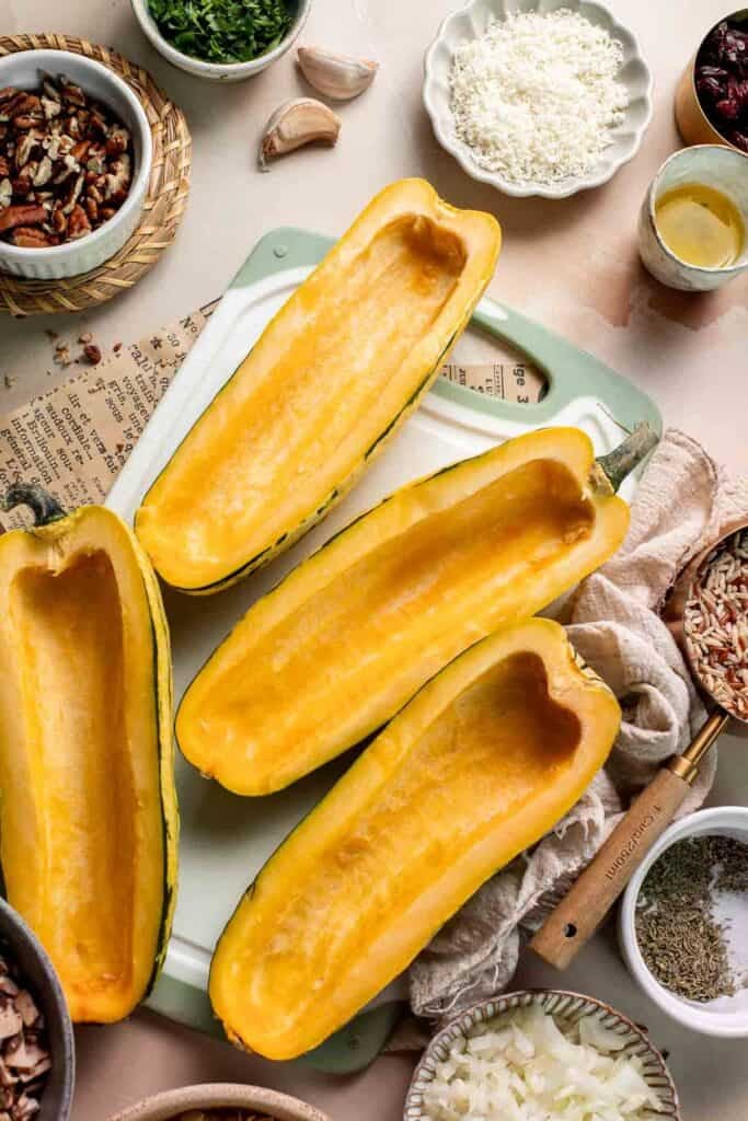 Delicata squash halves with the seeds scooped out.