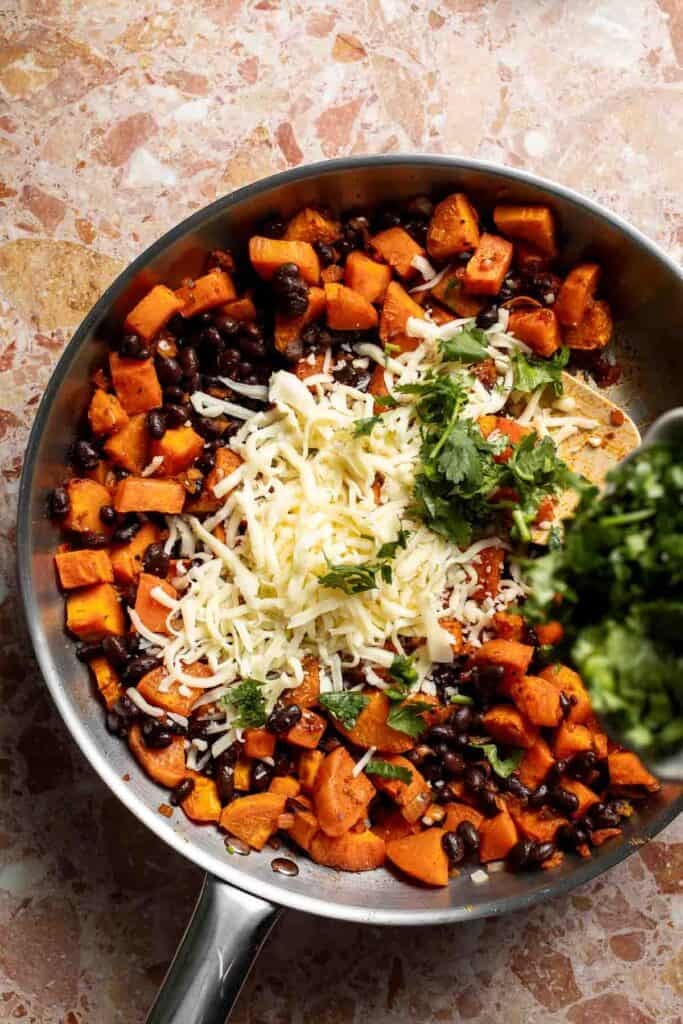Shredded Monterey Jack cheese and chopped cilantro added to the sweet potato filling.