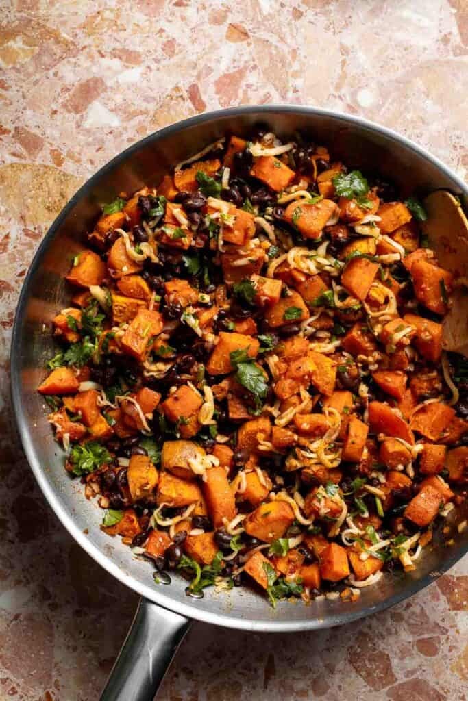 Cheese and cilantro folded into the finished sweet potato black bean filling.