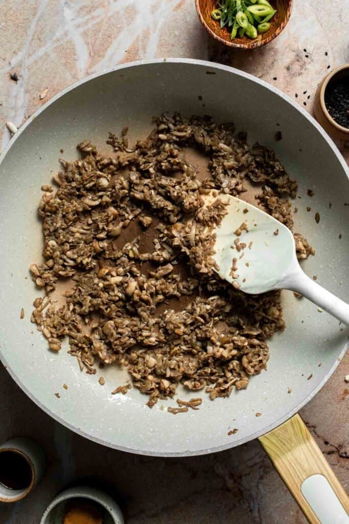 Mushrooms cooked down until browned and most of their moisture has evaporated.