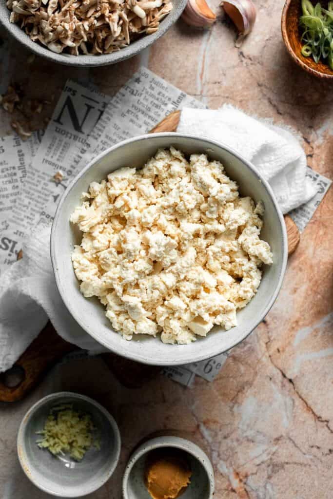 Finely crumbled tofu in a white bowl.