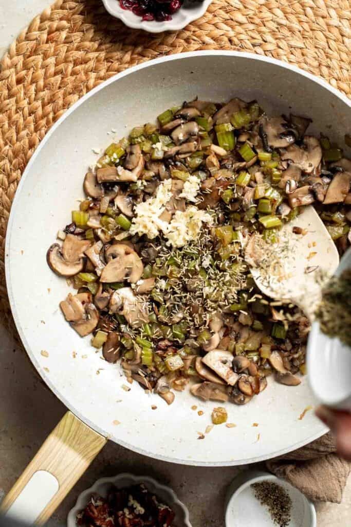 Minced garlic and dried herbs added to the mushroom mixture.