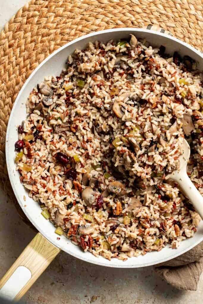 Wild rice stuffing tossed together with cranberries and pecans in the skillet.