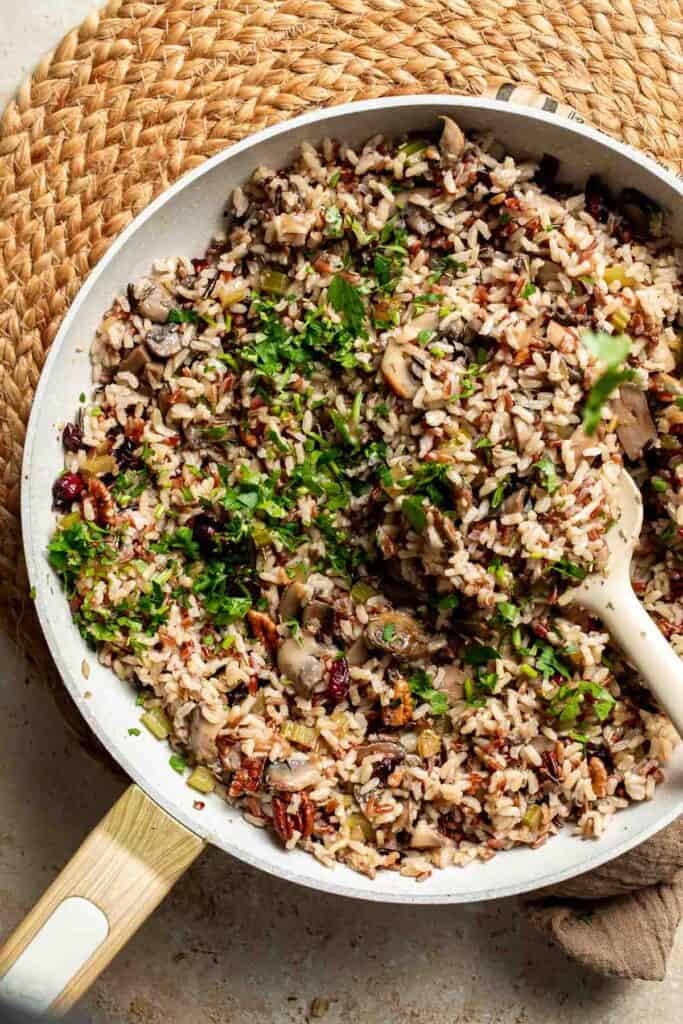 Fresh chopped parsley sprinkled over the wild rice stuffing in the skillet.