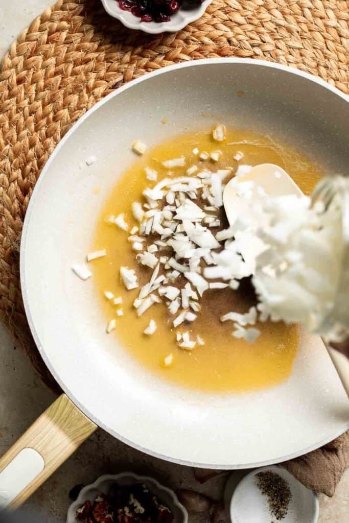 Diced onion added to melted butter and olive oil in a white skillet.