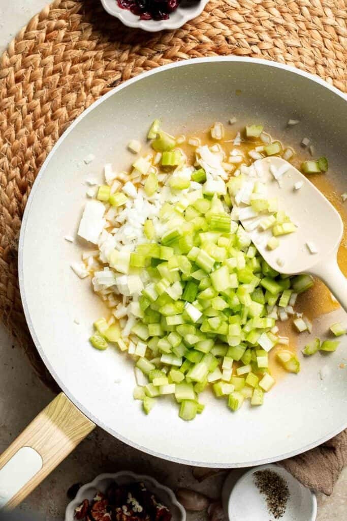 Diced onion and celery in the skillet, ready to sauté.